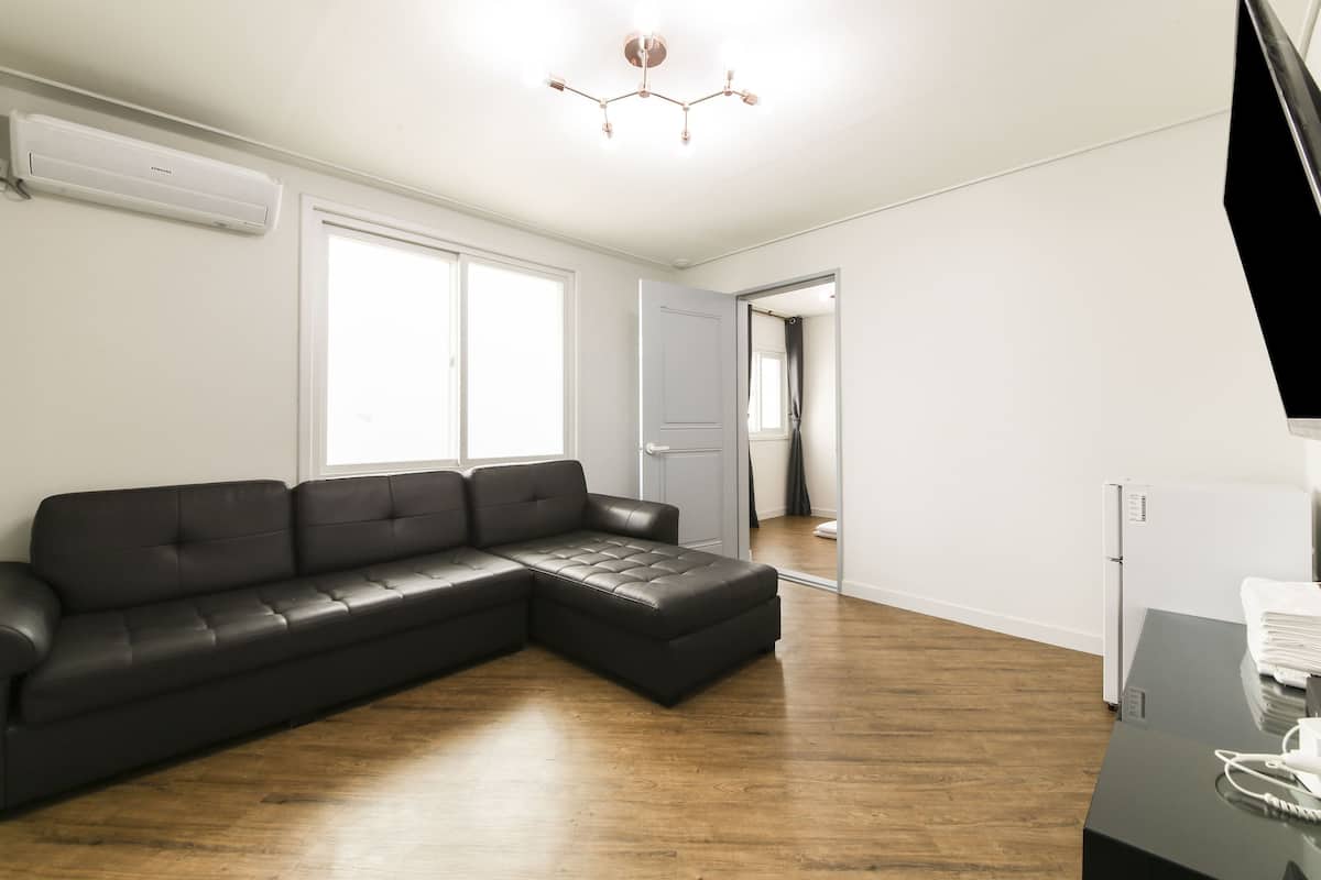 Family Premium Room | Living area | 50-inch flat-screen TV with cable channels, TV, first-run movies