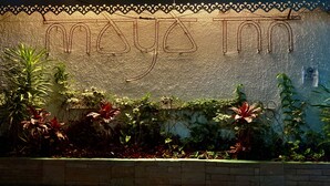 A wall with a decorative border and the text "Maya Inn" in a stylized font. - Maya Inn (Gangtok)