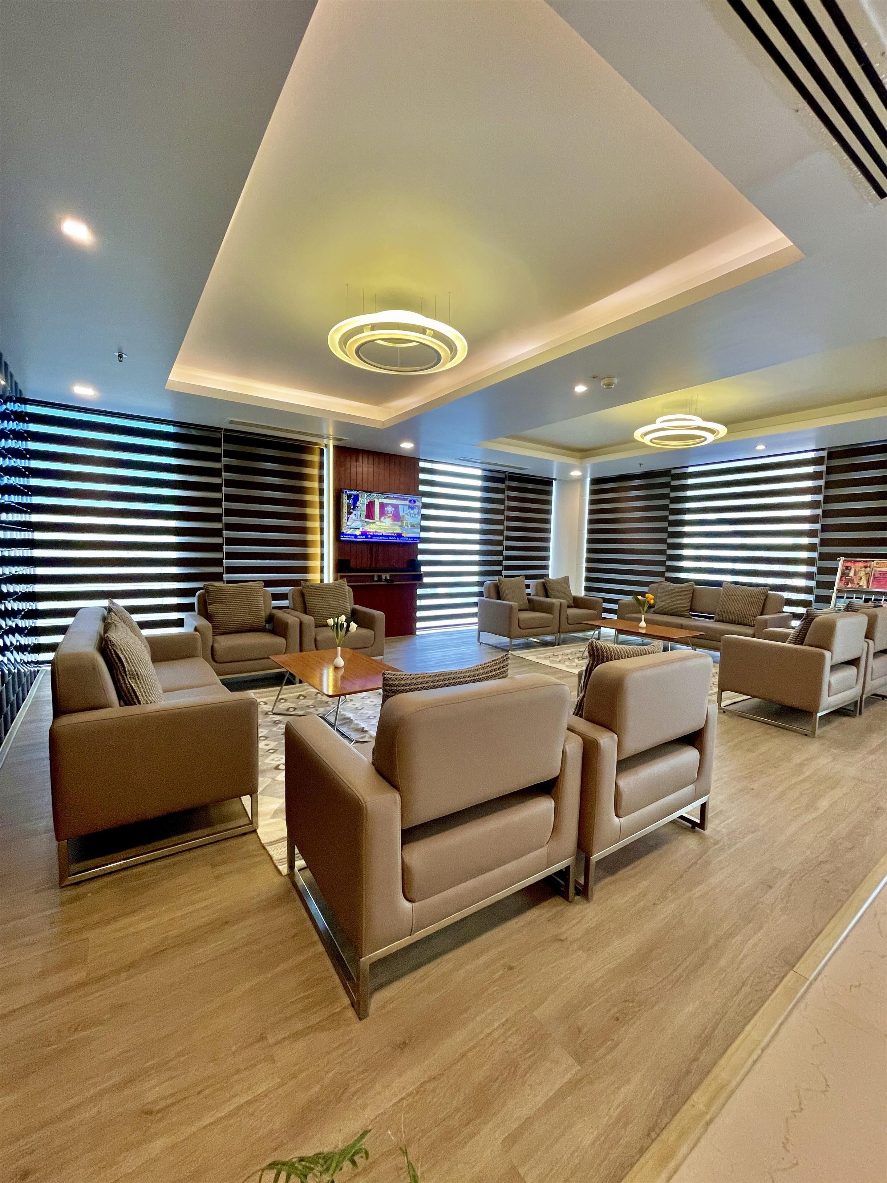 A modern living room with sofas, a coffee table, and a TV.