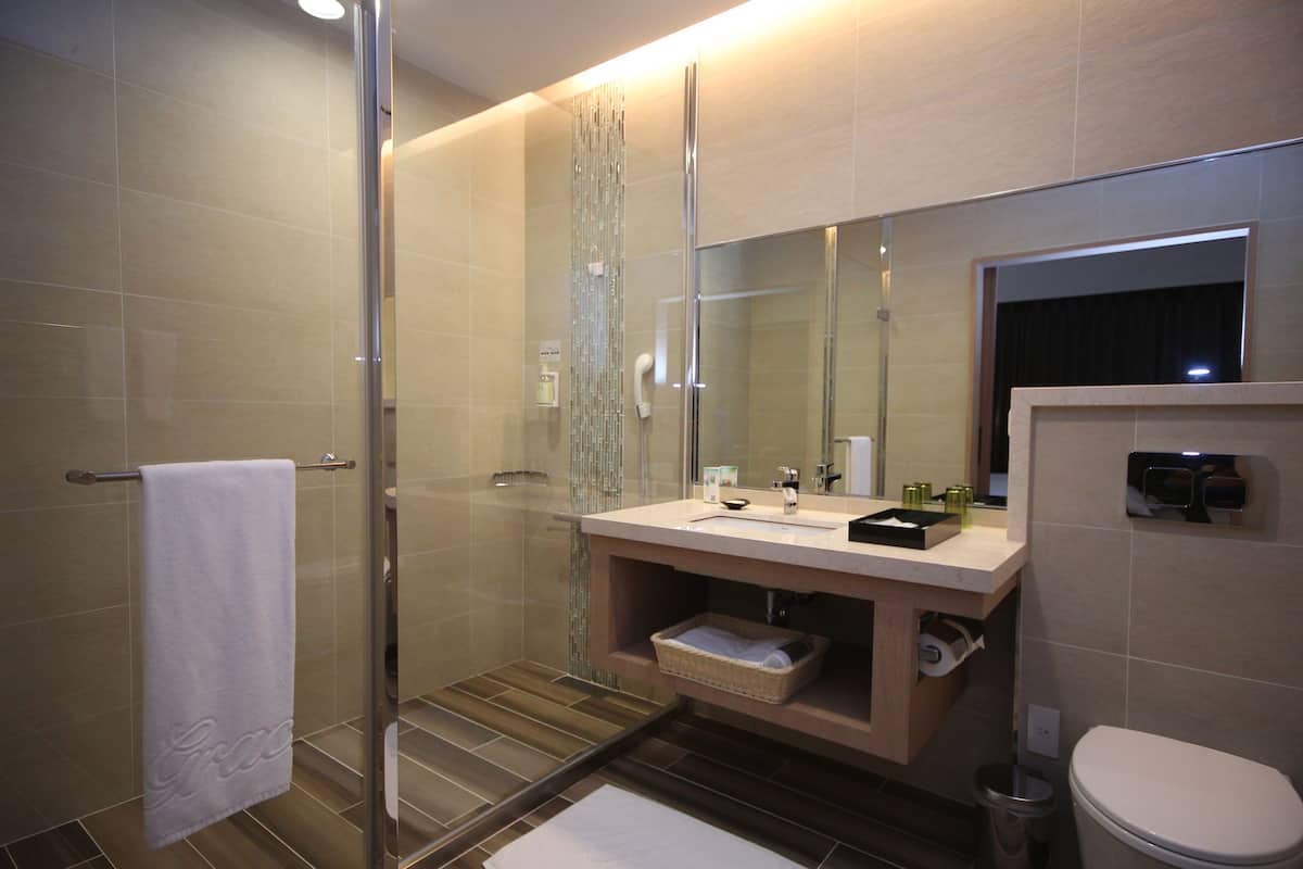 rainfall showerhead, hair dryer, slippers, towels