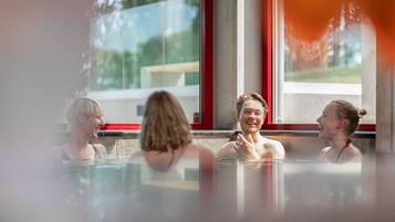 Relax and unwind in a hot tub with a view of the outdoors.
