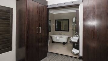 A modern bathroom with a freestanding bathtub, a sink, and a mirror.