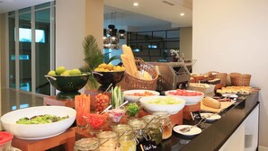A buffet with various food items including fruits, vegetables, and bread. - Swiss-Belresidences Kalibata Jakarta (Jakarta)