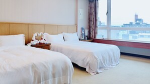 A hotel room with two beds, a nightstand, a window with a city view, and a wooden headboard. - Mucha Hotel (Yilan)