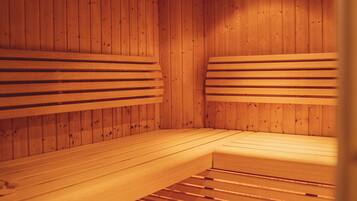 A sauna with wooden benches and a slatted floor.