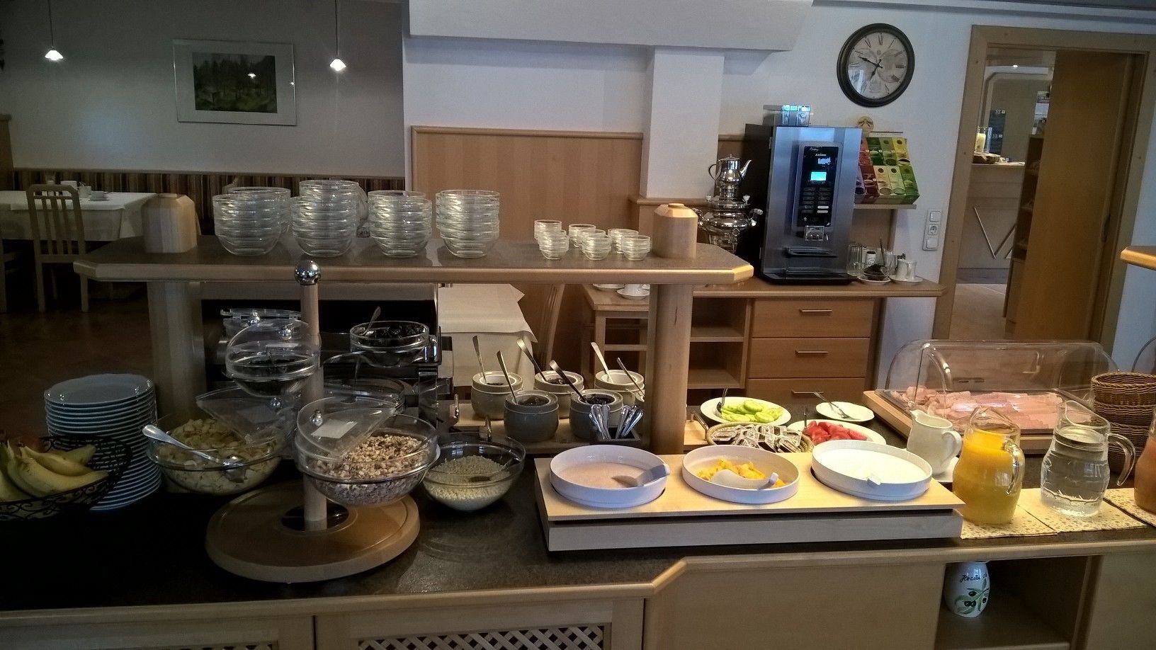 A buffet setup with various food items and serving utensils.