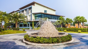 A modern building with a fountain in front. - Ray Hotel (Buriram)