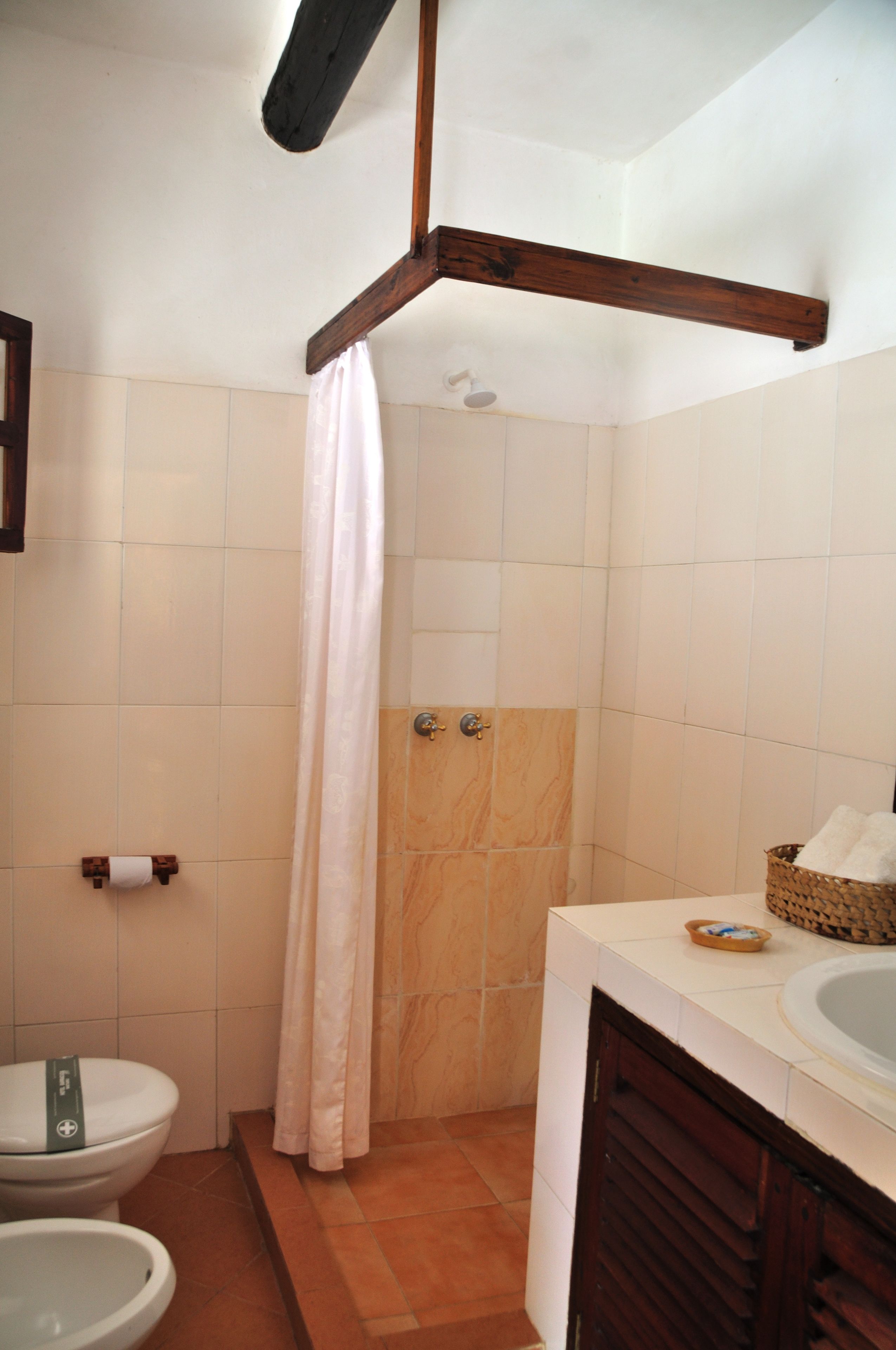 A bathroom with a shower, toilet, and sink.