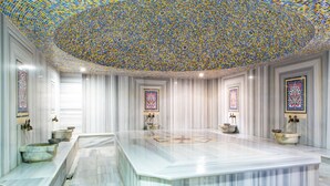 A luxurious bathroom with a large marble sink, decorative tiles on the ceiling, and framed artwork on the walls. - Gardenia Beach Hotel - All Inclusive (Alanya)