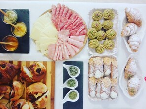A variety of food items including meats, cheeses, pastries, and dips. - Alloggio della Posta Vecchia (Agrigento)