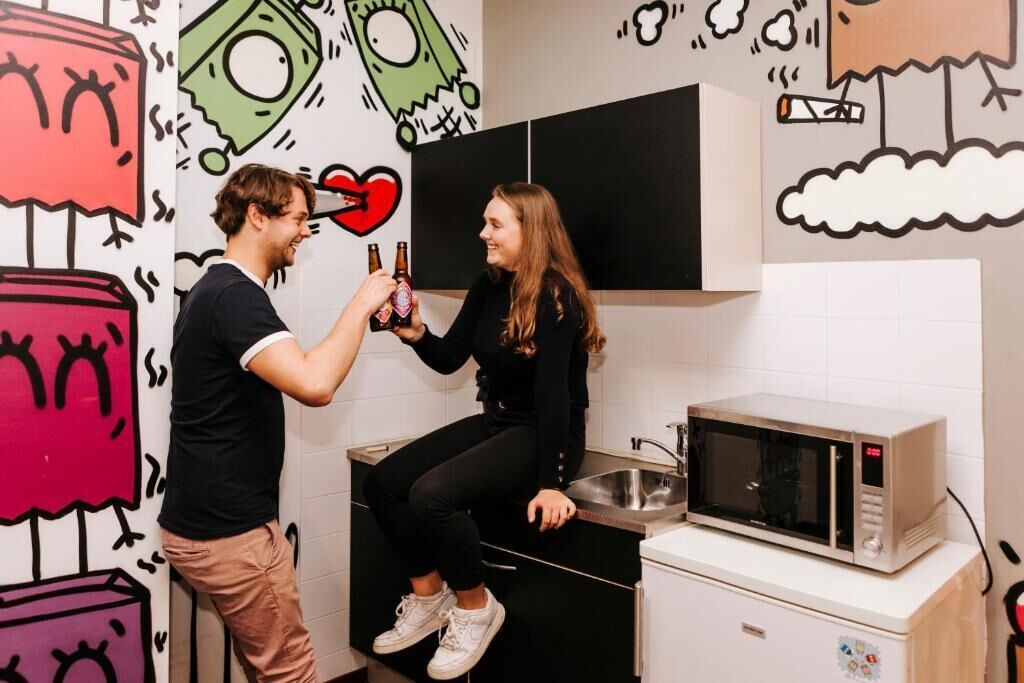 A kitchen with a microwave on a counter, a sink, and a cabinet.