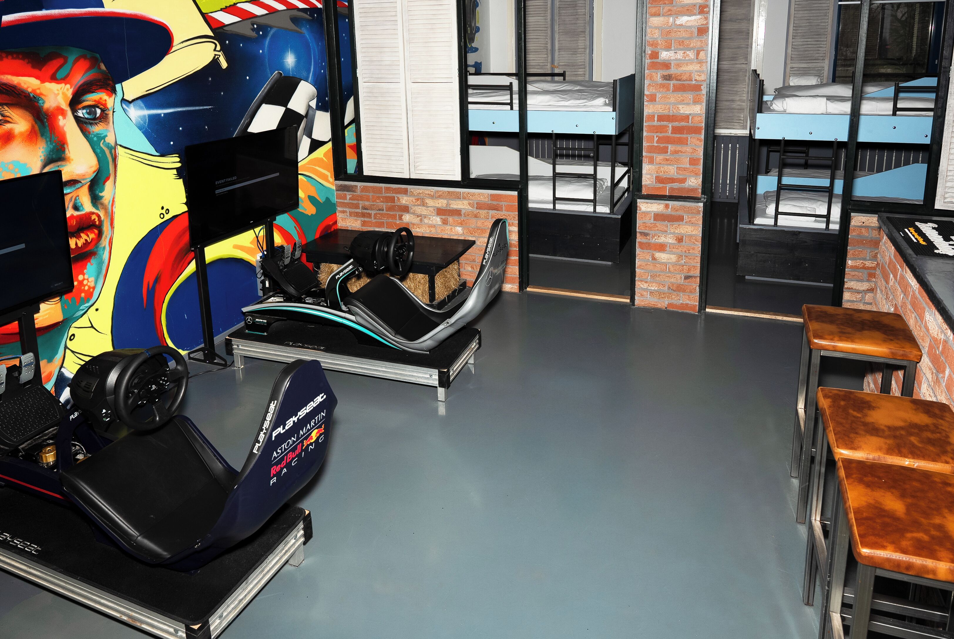 A room with a treadmill, a mural, bunk beds, and a brick wall.