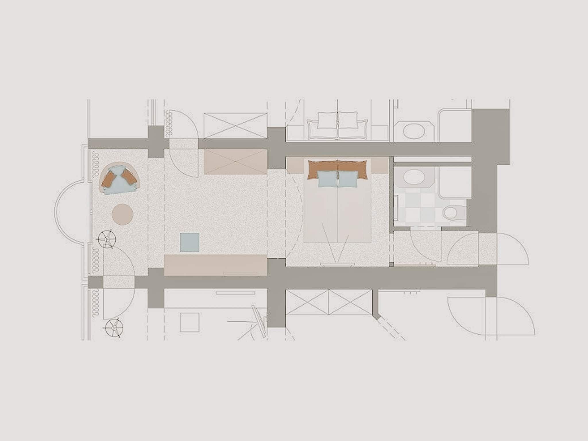 Plano de planta de un hotel que muestra una zona de estar central, una cocina, un comedor y un baño.