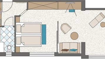 A floor plan of a hotel room with a kitchenette, two beds, a seating area with a table and chairs, and a small bathroom.
