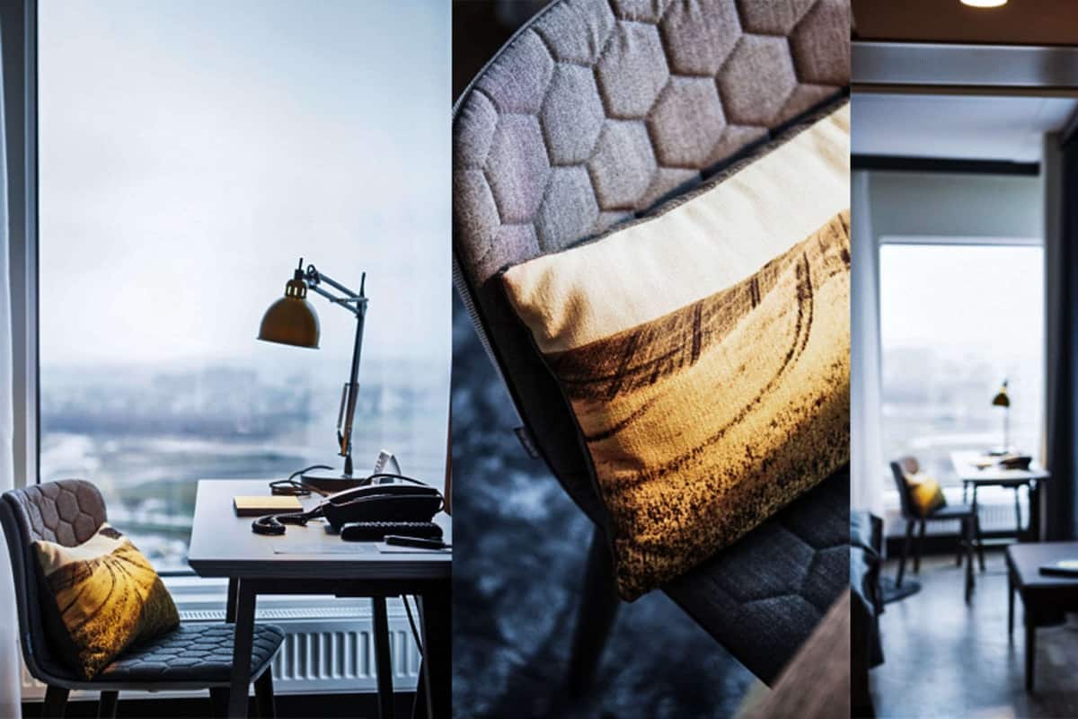A modern office space with a desk, chair, and lamp.