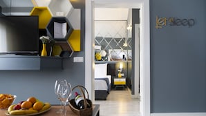 A modern hotel room with a bed, bedside table, and a wall-mounted TV. - Letstay Hotel - Adult Only +12 (Antalya)