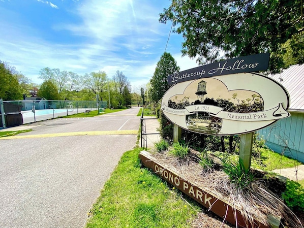 A sign for Buttercup Hollow, Orono Community, established in 1923, and Memorial Park.