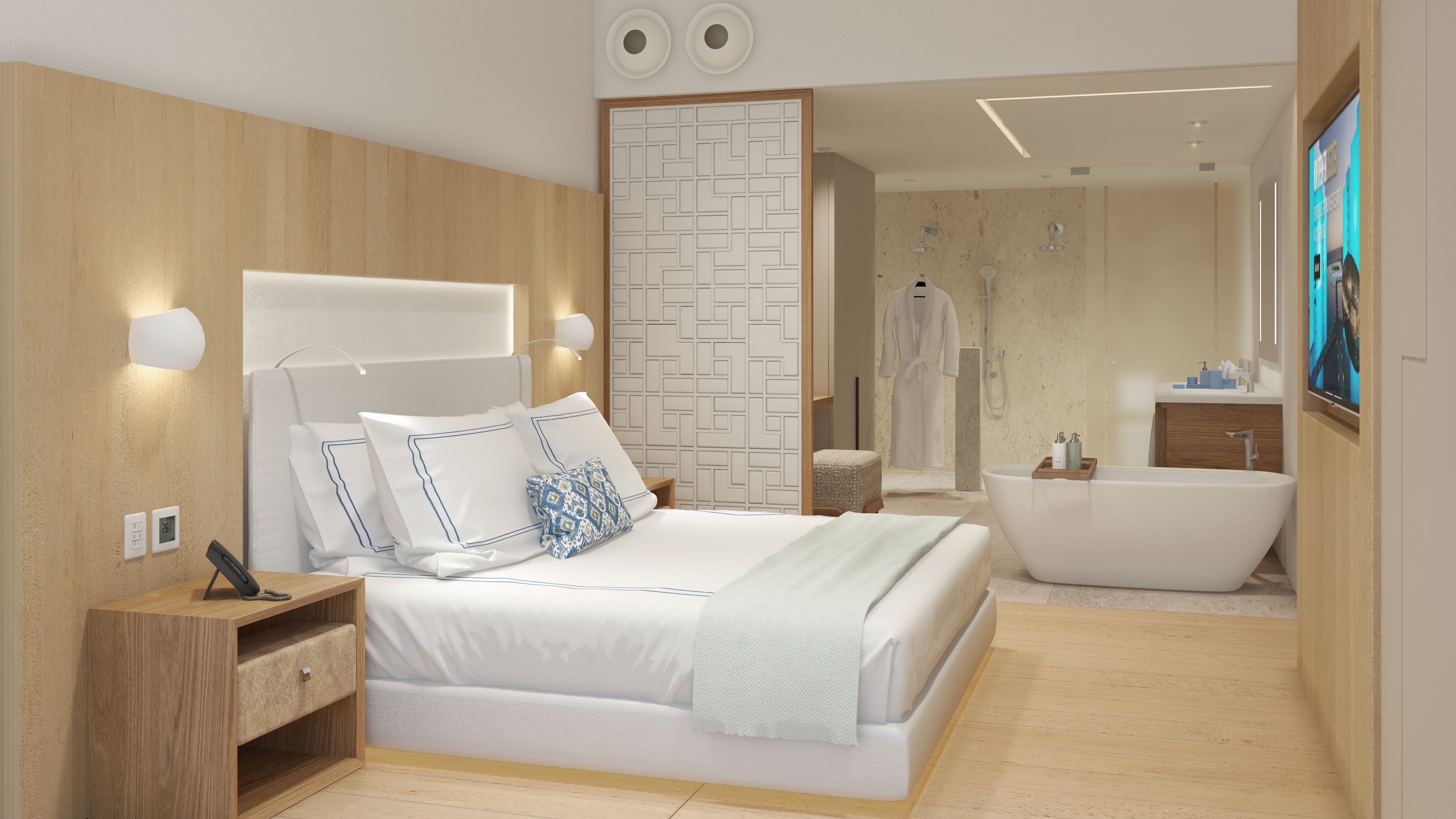 Quarto moderno com uma cama grande, luminárias de cabeceira, mesa de cabeceira e vista para o banheiro.