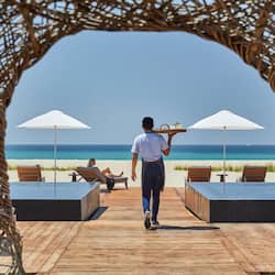 On the beach, white sand, beach cabanas, sun loungers
