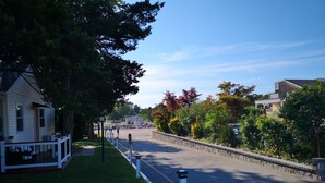 A quiet street with a white fence, a bench, and a house on the left. - Baywatch Hotel & Marina (Hampton Bays)