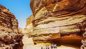 A natural rock formation with a pool at its base, surrounded by steep cliffs. - Hospedaje Claudia (Ica)
