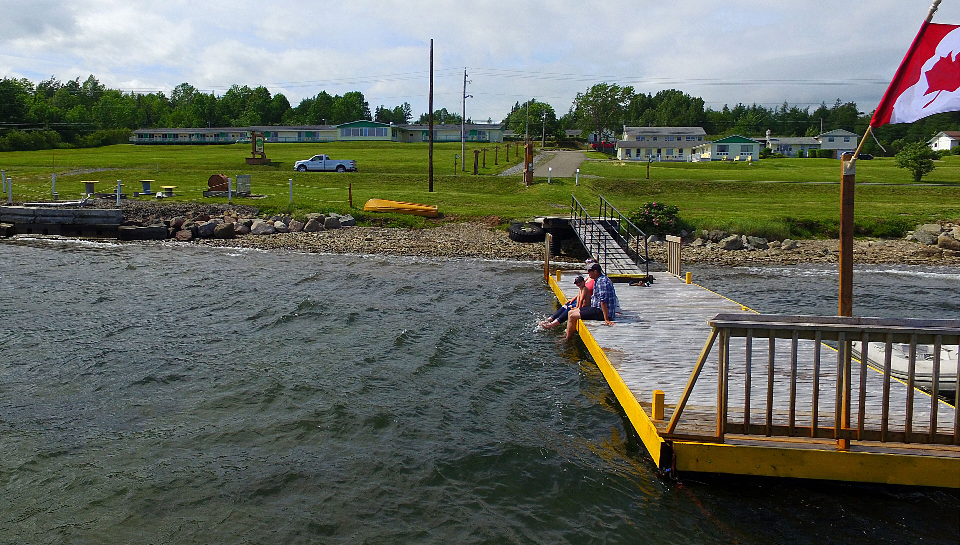 A dock extending into a river with a wooden walkway.