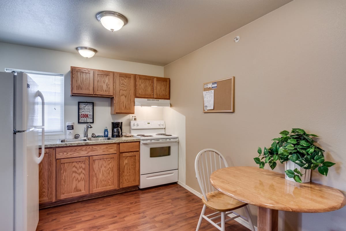 One Bedroom Queen Suite | Private kitchen | Full-sized fridge, microwave, oven, stovetop