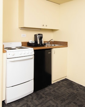 In-room safe, desk, laptop workspace, blackout drapes at Ohia Waikiki Studio Suites