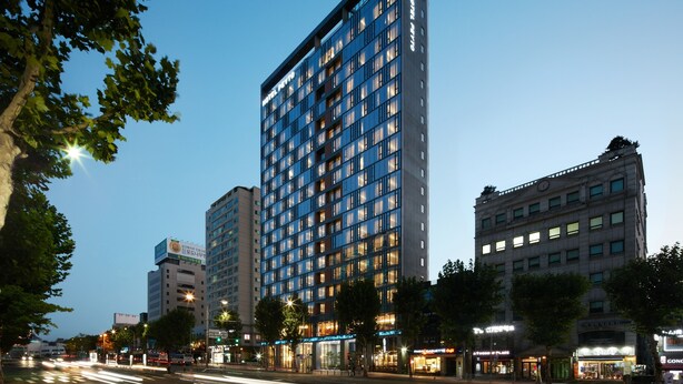 A modern hotel with a rectangular facade, multiple floors, and illuminated windows. - Hotel Peyto Gangnam (Seoul)
