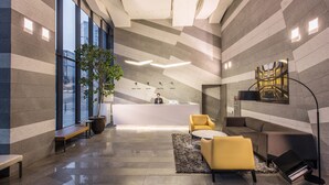 A modern lobby with a reception desk, seating area, and large windows. - Hotel Peyto Gangnam (Seoul)