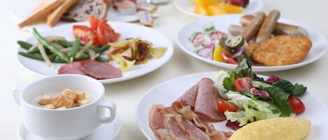 A breakfast spread with various dishes including toast, eggs, bacon, and a salad.