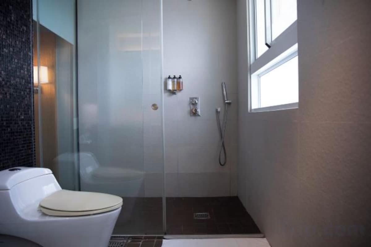 Bathroom | Designer toiletries, hair dryer, slippers, towels
