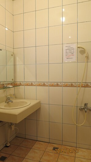 A bathroom with a sink, mirror, and shower. - Quan Fu Tan Hui Hotel (Yuchi)