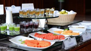 A buffet with various food items and drinks.