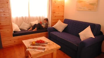 Family Chalet, 1 Bedroom, Jetted Tub | Living area | 21-inch flat-screen TV with cable channels, TV