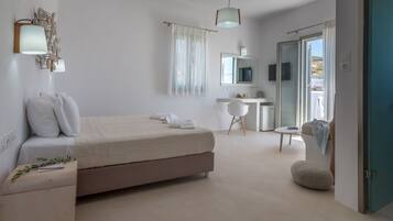 A modern bedroom with a bed, bedside table, and a desk with a chair.