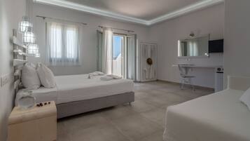 A modern hotel room with a large bed, a bedside table, a chair, a TV, and a bathroom with a shower and toilet.
