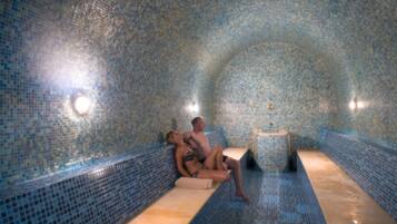 Relax by the serene pool, surrounded by a beautiful mosaic tile design and two benches for unwinding.