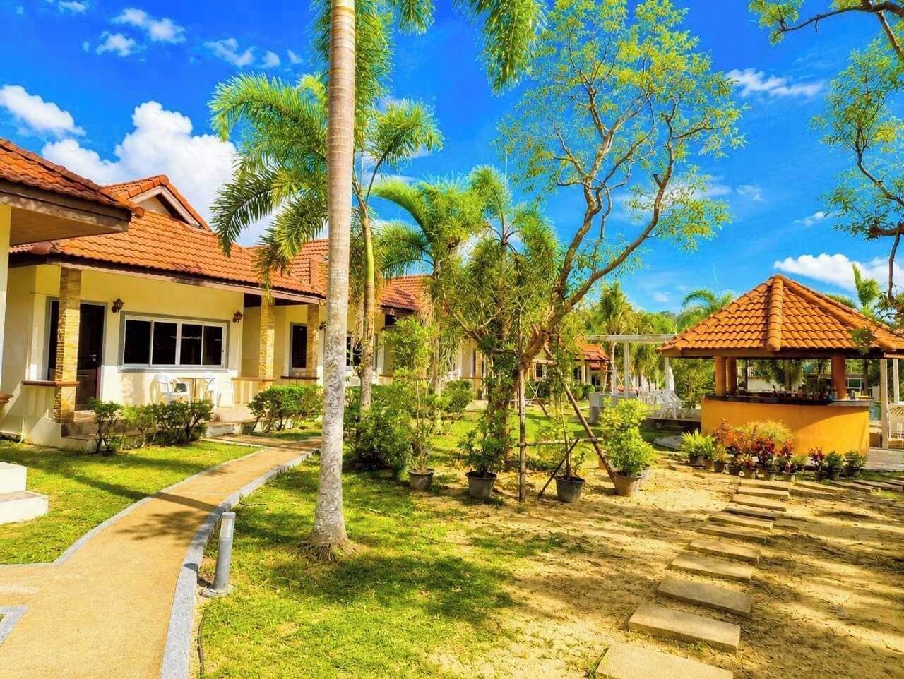 A residential area with houses, a pathway, and a gazebo.