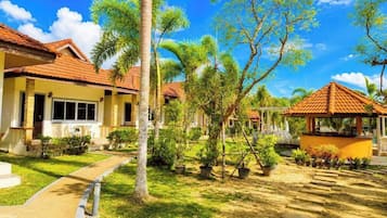 A residential area with houses, a pathway, and a gazebo.