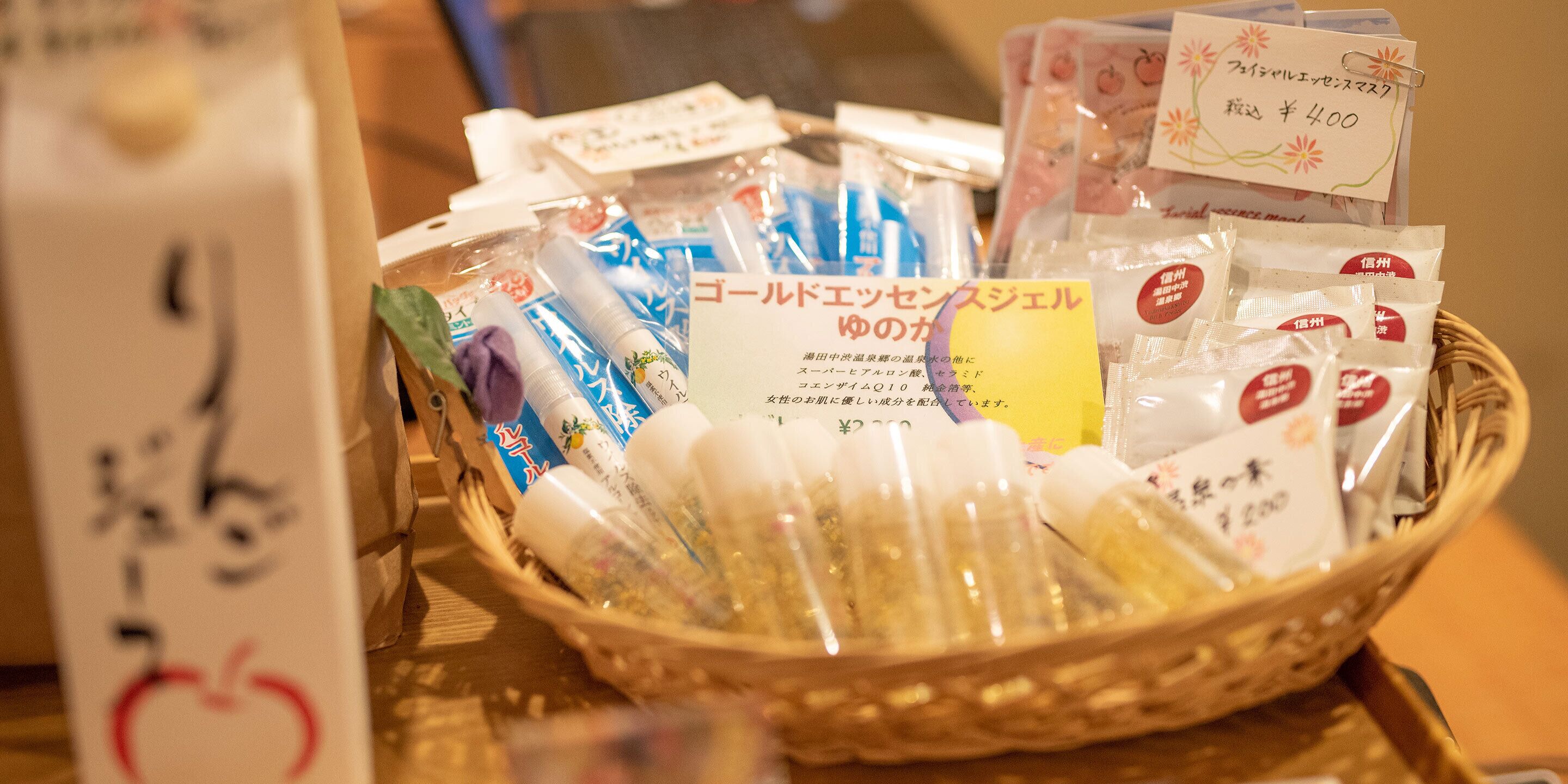 A basket filled with various packaged items, some with labels and price tags.