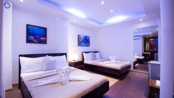 Deluxe Room (Interior Quad) | In-room safe, desk, blackout drapes, iron/ironing board