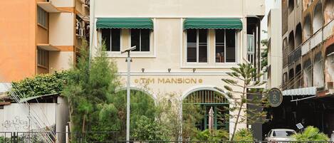 A building with a sign reading "TIM MANSION".