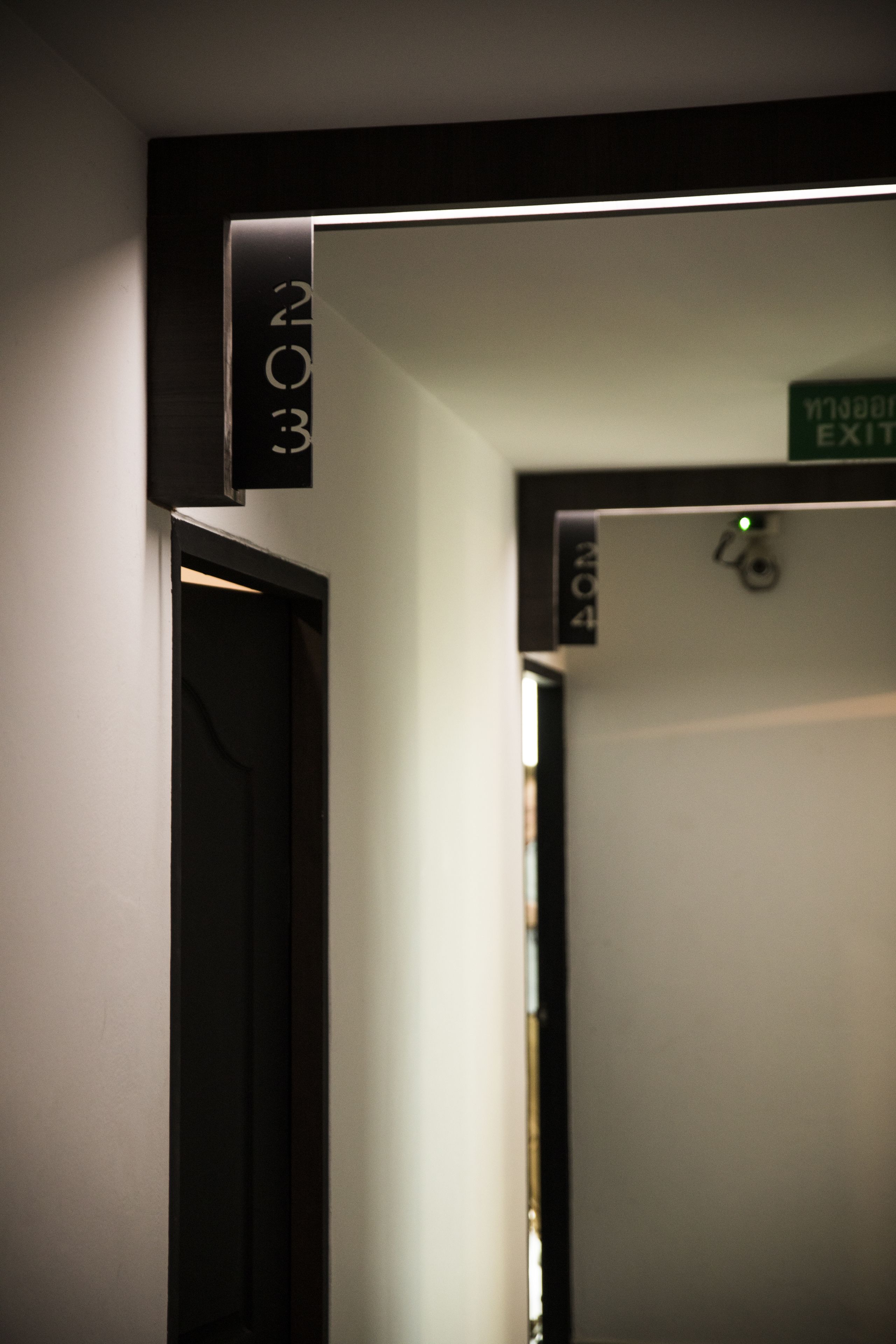 A corridor with a door labeled "EXIT" and a sign indicating "EXIT" above it.