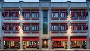 A hotel with a 1950 facade, multiple balconies, and red awnings. - The Vagabond Club, Singapore, a Tribute Portfolio Hotel (Singapore)