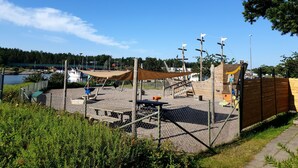A playground with climbing structures and a picnic table. - Segelfartyget Libelle (Oxelosund)