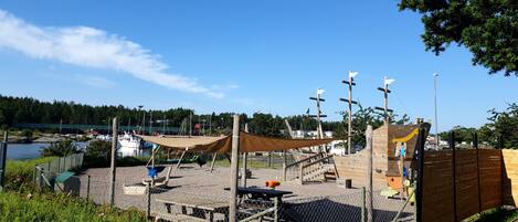 A playground with climbing structures and a picnic table.