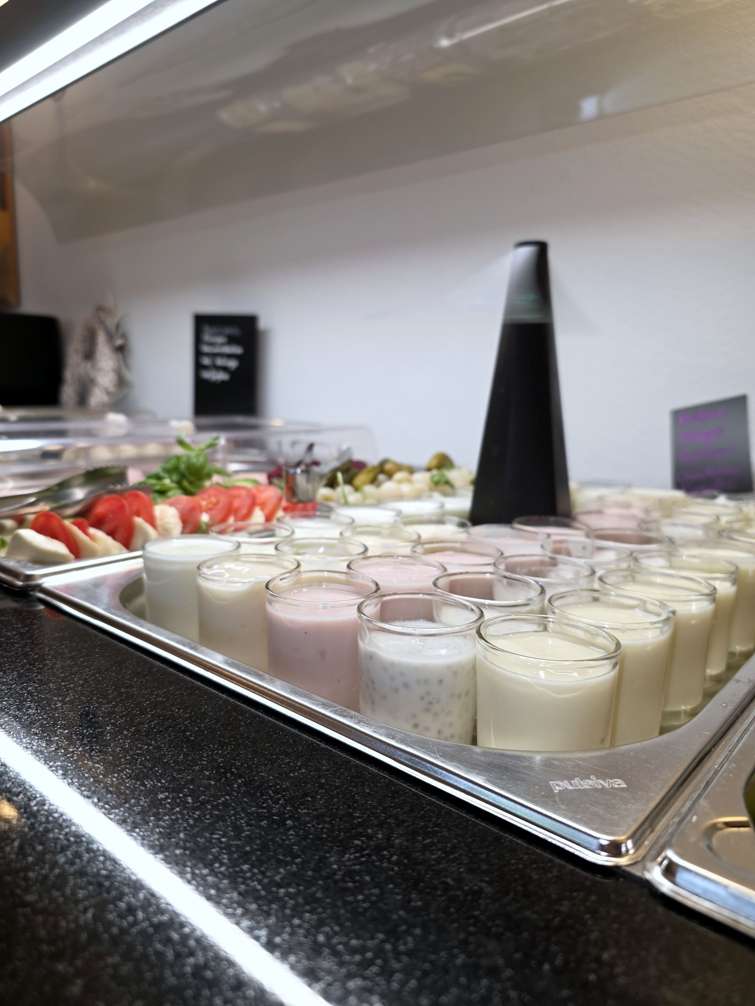 A buffet with various food items and beverages.