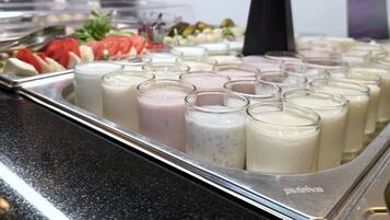 A buffet with various food items and beverages.
