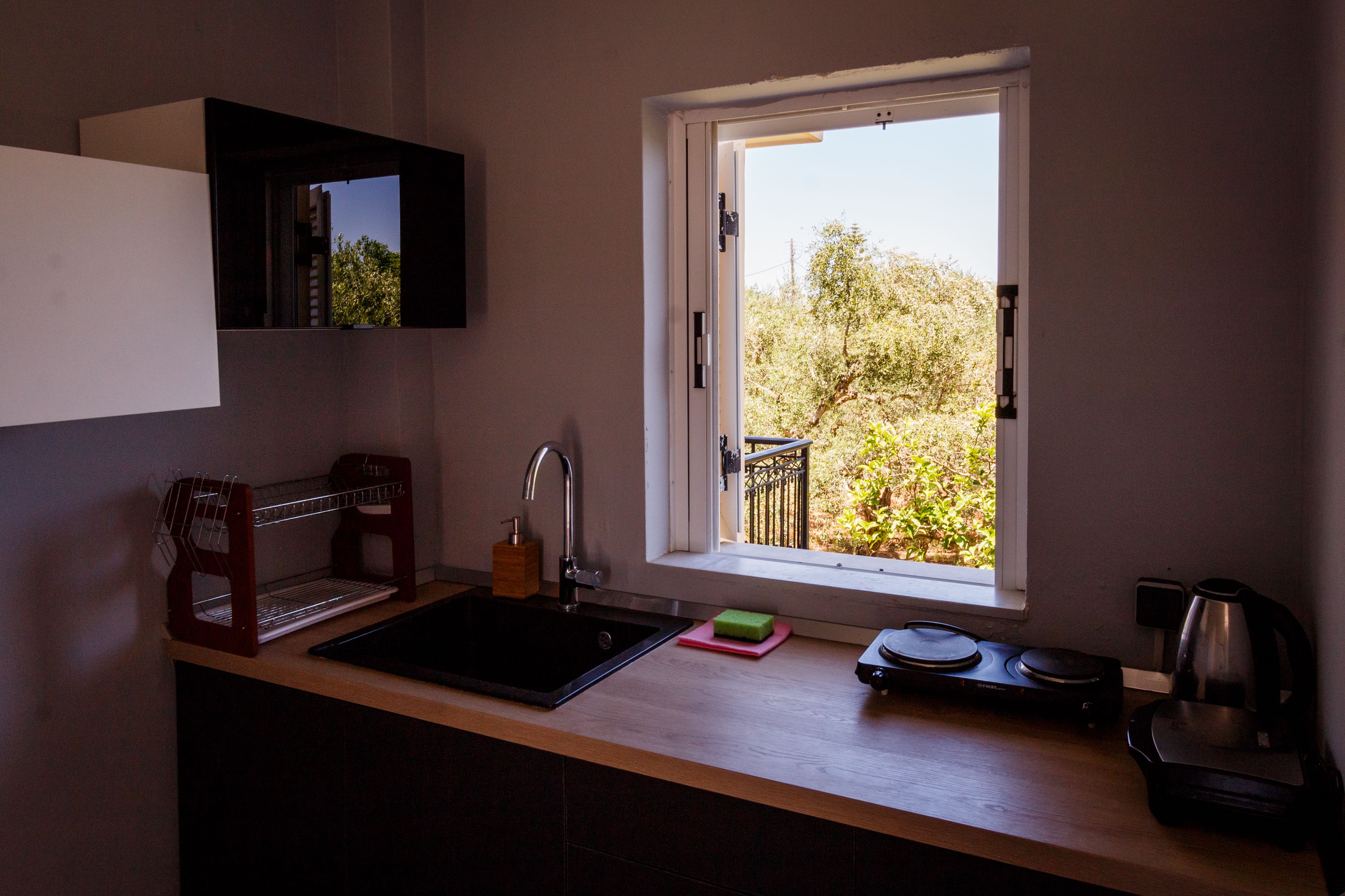 A kitchen with a window, sink, and countertop.
